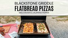 two flatbread pizzas cooking on an outdoor grill with picnic table and checkered cloth