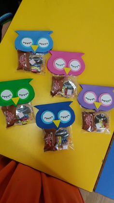 four bags of candy with owls on them sitting on a table next to each other