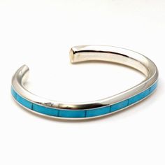 Exquisite turquoise inlay technique by Zuni silversmith Johnathon Natachu is displayed in this attractive sterling silver bracelet. Just over 1/4" wide and 5 " inside tip to tip with a 1 gap this bracelet will fit a wrist circumference of up 6 ". This bracelet is not adjustable. Weight approximately 34.4 grams. Turquoise Sterling Silver Cuff Bracelet With Polished Finish, Turquoise Sterling Silver Cuff Bracelet With Inlay, Sterling Silver Turquoise Cuff Bracelet With Inlay, Sterling Silver Bracelet, Sterling Silver Bracelets, Silver Bracelet, Gap, Thing 1, Turquoise