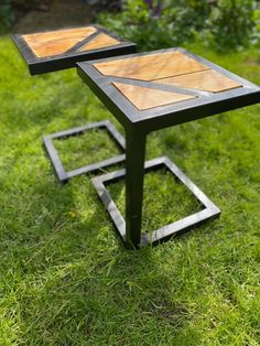 two tables sitting on top of green grass