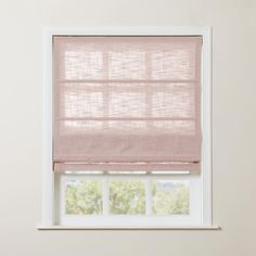 a pink roman blind in front of a window