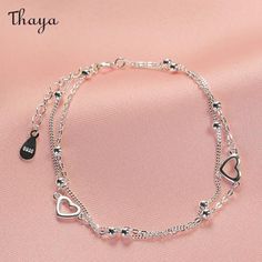 Design concept     The slender double-layered chain is lovely. The hollow love heart and round beads add a sweet touch, wrapping around the wrist and highlighting the slender and white wrist. How can spring outfits be missing this touch of sweetness, which will show delicate and soft beauty and charming temperament.     Detail    Brand: Thaya  Material: 925 Silver + oxidation  Gender:Female  Size: Chain length about 15+3cm extension chain, love about 0.9cm  Weight: About 1.78g Trendy Silver Charm Bracelet With Heart Beads, Minimalist Heart Beads Bracelet, Trendy Silver Heart Bracelet With Adjustable Chain, Trendy Silver Heart Beads Bracelet, Trendy Silver Bracelets With Heart Beads, Double Heart Bracelet With Adjustable Chain, Silver Bracelets For Spring, Elegant Heart Jewelry For Spring, Elegant Heart Shaped Jewelry For Spring