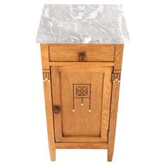 a small wooden cabinet with marble top