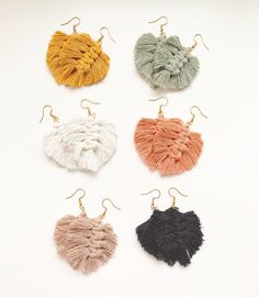 four pairs of tasseled earrings in various colors