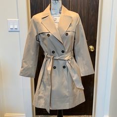 Tommy Hilfiger Trench/Rain Jacket With Satin Lining. Women’s Size Medium But Was Altered To Fit My Cousin With Down’s Syndrome. So Made Into A Petite. She Didn’t Like It So Never Worn. Pit To Bottom Of Sleeves: 15” Shoulder To Hem: 33 3/4” Casual Tommy Hilfiger Outerwear For Spring, Tommy Hilfiger Casual Spring Outerwear, Elegant Tommy Hilfiger Outerwear For Work, Fitted Beige Outerwear For Spring, Tommy Hilfiger Classic Long Sleeve Outerwear, Tommy Hilfiger Single Breasted Work Outerwear, Classic Tommy Hilfiger Long Sleeve Outerwear, Tommy Hilfiger Fall Outerwear With Pockets, Elegant Tommy Hilfiger Long Sleeve Outerwear