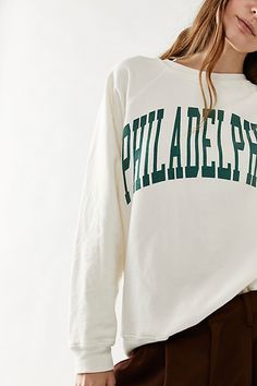 Just as effortless as it is essential, this goes-with-everything crewneck sweatshirt is featured in a classic oversized, slouchy silhouette and soft, washed cotton fabrication with city graphic at front for timeless style. * Scoop neckline * Classic, slouchy fit * Light distressing throughout | Classic Crew Sweatshirt by Original Retro Brand at Free People in Green, Size: XL Angel Baby Clothes, City Graphic, Tunic Hoodie, Retro Brand, Oversized Crewneck, Free People Clothing, Crew Sweatshirts, Print Pullover, Boho Clothing