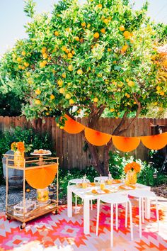 an outdoor party with oranges and decorations