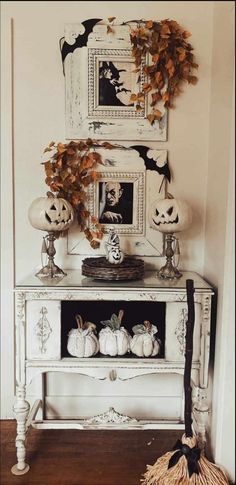 a white table with pumpkins and other decorations on it in front of a mirror