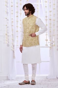 Gold bundi with dori embroidery in floral pattern. Paired with full sleeve kurta and pant. - Aza Fashions Festive Kurta With Floral Embroidery And Stand Collar, Traditional Spring Nehru Jacket With Dabka, Festive Stand Collar Kurta With Floral Embroidery, Spring Wedding Nehru Jacket With Dabka, Fitted Nehru Jacket With Zari Work For Puja, Traditional Sherwani With Pallu For Spring, Spring Wedding Nehru Jacket In Chanderi, Fitted Nehru Jacket For Puja And Eid, Fitted Nehru Jacket With Cutdana For Puja