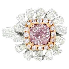 a pink diamond ring with white and yellow diamonds