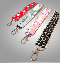 three lanyards with hearts on them and one has a pair of scissors in it