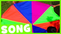 there is a colorful umbrella with the words song in front of it and people standing around