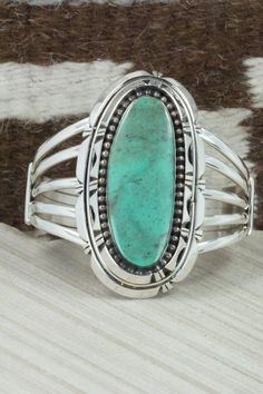 This Kingman turquoise and sterling silver bracelet was made by Navajo silversmith Rita Lee. The inside is signed RL and stamped sterling.Size: 5 7/8" (will fit up to a 6 3/4" wrist)Gap: 7/8"Length: 2 5/8"Width: 1 1/2"Free shipping on all orders! We ship with USPS and always include tracking. All orders ship within a day of payment.Returns are accepted up to 30 days after you receive your order. Just send us a message. Our shop offers cash back or store credit. The item must be returned in new c Classic Turquoise Sterling Silver Bracelets, Southwestern Oval Sterling Silver Cuff Bracelet, Oval Southwestern Sterling Silver Cuff Bracelet, Southwestern Style Oval Sterling Silver Cuff Bracelet, Oval Sterling Silver Cuff Bracelet In Southwestern Style, Kingman Turquoise, Pretty Rings, Sterling Silver Bracelet, Cuff Bangles