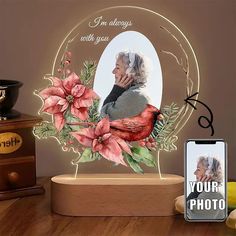 an old woman with flowers on her face is shown in front of a photo frame