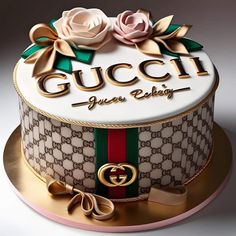 a gucci cake with flowers and ribbons on top