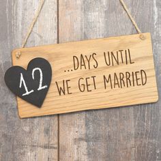 a wooden sign that says days until we get married