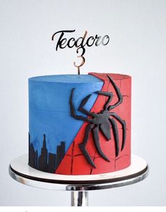 a spiderman cake with the number 3 on it and a name that says tegoco