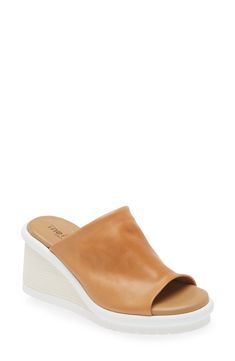 A textured wedge lofts a versatile slide sandal crafted with a smooth, supple leather upper. 3" heel; 1 1/2" platform (size 39) Cushioned insole Leather upper and lining/synthetic sole Made in Italy Modern Wedge Heels With Cushioned Footbed, Modern Cushioned Wedge Heels, Spring Slides With Leather Footbed And Wedge Heel, Spring Wedge Heel Slides With Cushioned Footbed, Spring Cushioned Wedge Heel Slides, Spring Leather Footbed Wedge Heel Slides, Spring Wedge Heel Slides With Leather Footbed, Spring Leather Slides With Wedge Heel, Modern Open Toe Platform Slippers With Textured Sole