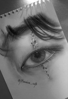 a drawing of an eye with long lashes and beads on it's eyelashes, in black and white