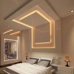 a bed room with a neatly made bed and some lights on the wall above it