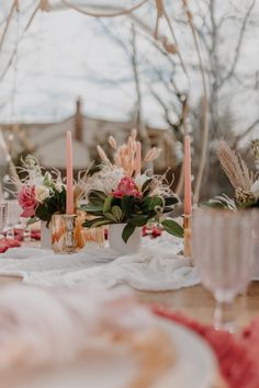 the table is set with candles and flowers