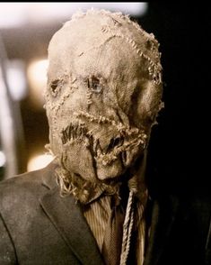 a creepy looking man in a suit and tie with his face covered by hair that has been torn off