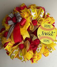 a yellow and red baseball wreath with the words home sweet home