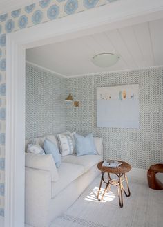 a living room with blue and white wallpaper