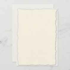 a blank paper wedding card on a marble background with the words, deksled edge paper wedding