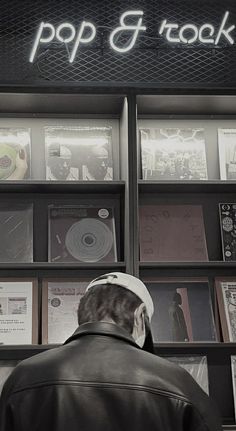 a man standing in front of a record store