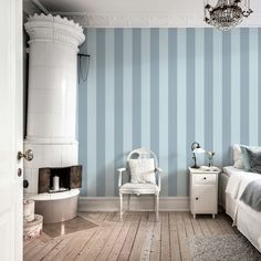 a bedroom with blue and white striped walls