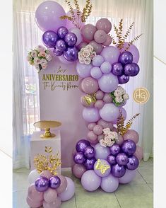 balloons and flowers are arranged in the shape of an arch for a birthday party decoration