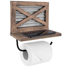 a laptop computer on top of a wooden shelf above a roll of toilet paper and a tissue dispenser