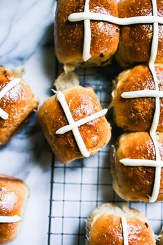 hot cross buns with white icing on a cooling rack, ready to be eaten