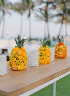 pineapples and flowers are arranged on a table