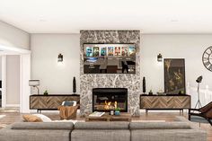 a living room with couches, chairs and a fire place in the middle of it