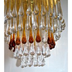 a chandelier with many different colored glass drops hanging from it's sides