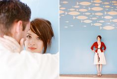 a woman standing next to a man in front of a wall with fish on it