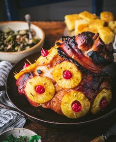 a plate topped with pineapples, bacon and pineapple slices next to other food