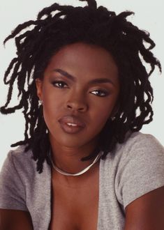 a woman with dreadlocks is posing for the camera