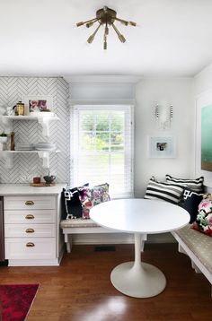 a white table and bench in a room