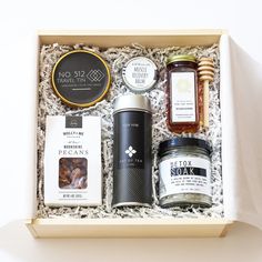 an open gift box containing honey, jams and other items in the same package