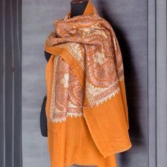 Exquisite fabric made of handmade shawl, harmonious masterpiece combining beauty and practicality. This stunning shawl, carefully crafted, has a saturated orange hue that radiates heat. The shawl is decorated with a charming floral pattern adorning the entire space of the shawl. Exquisite embroidery, decorated with bright shades of beige and bronze colors, adds elegance to the elegant design of nature. In addition to its exquisite beauty, this shawl is a wonderful gift that interweaves aesthetic Beige Embroidery, Bohemian Scarf, Bohemian Scarves, Long Cape, Shades Of Beige, Pashmina Shawl, Bronze Color, Shawls And Wraps, Elegant Design