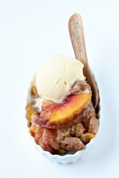 an ice cream sundae with peaches and cinnamon on top is ready to be eaten