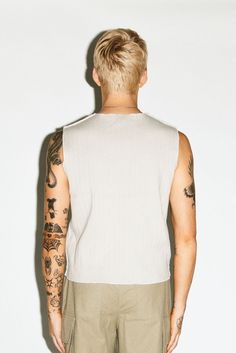 A 90's counter-culture sleeveless muscle tank. Distressed hems, cropped waistband and raw-edge seams add a gritty edge to a minimalist bicep-revealing silhouette. Constructed in an ultra-thick 2-ply ribbed cotton to be worn solo as a statement on its own. Summer Tank Top With Dropped Armholes For Everyday, Summer Muscle Tee With Dropped Armholes, Cropped Muscle Tee With Relaxed Fit For Summer, Summer Cropped Muscle Tee Relaxed Fit, Summer Relaxed Fit Cropped Muscle Tee, Summer Cropped Muscle Tee In Relaxed Fit, Cropped Muscle Tee For Summer, Fitted Cropped Muscle Tee For Summer, Summer Fitted Cropped Muscle Tee