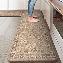 a woman standing on a rug in the middle of a kitchen looking at an oven