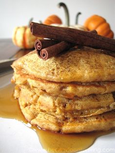 a stack of pancakes with cinnamon and syrup