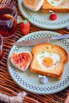 toast with jam and an egg in the middle on a plate next to strawberries