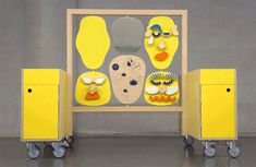 a group of yellow objects sitting on top of each other in front of a gray wall