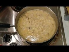 a pan filled with food sitting on top of a stove next to a burner